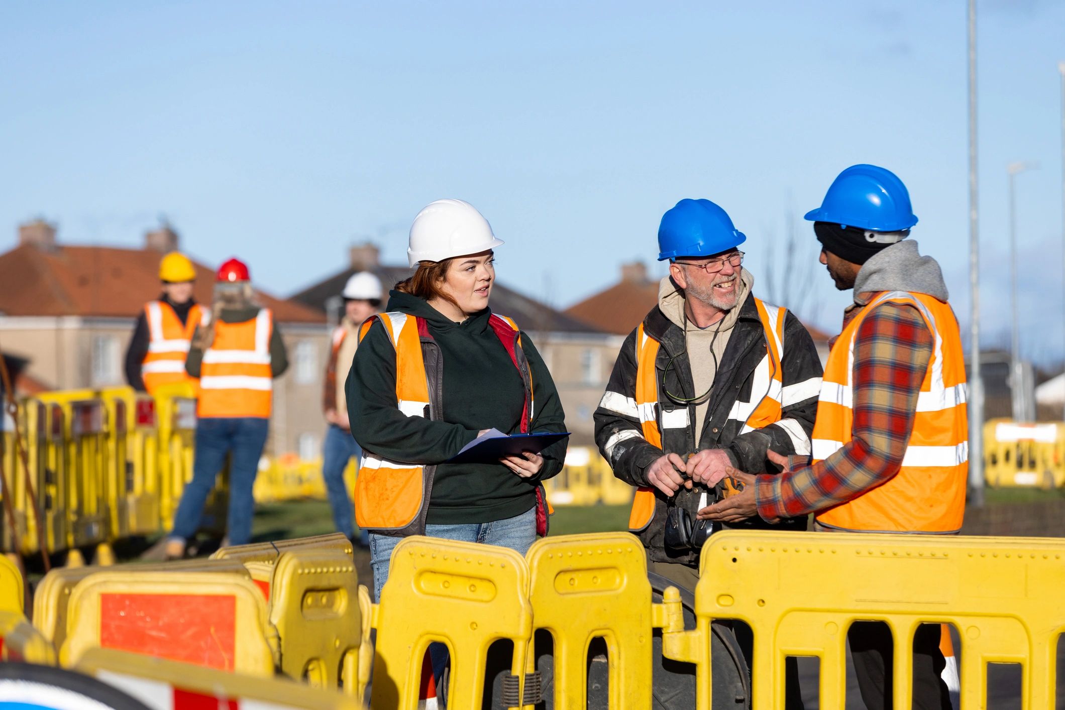 Field team reviewing work plans at an outdoor site