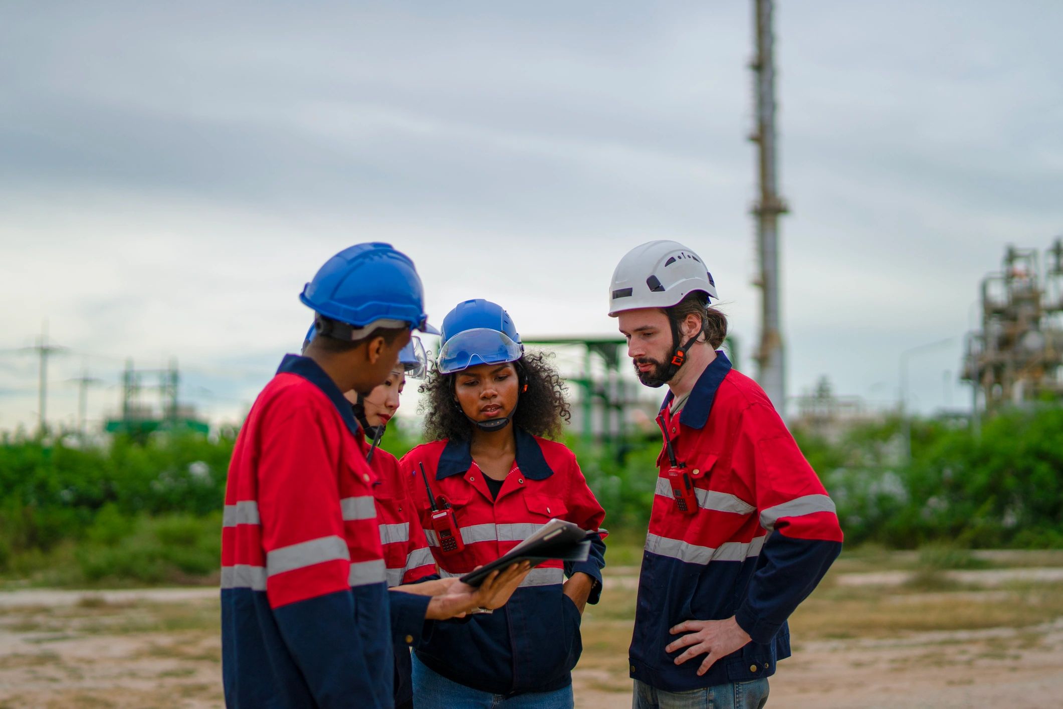 Industrial workers standing together at an active job site