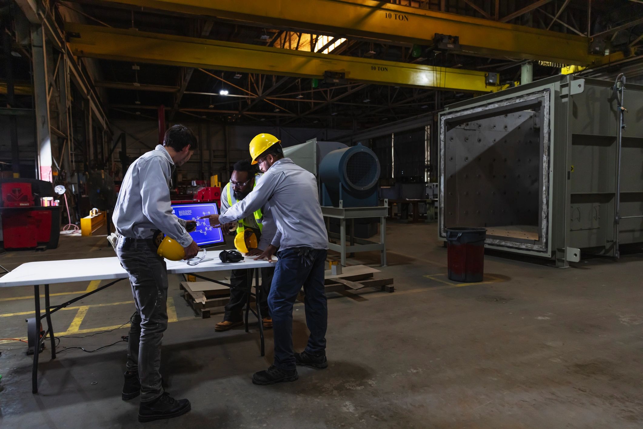 Industrial team reviewing safety systems on a factory floor